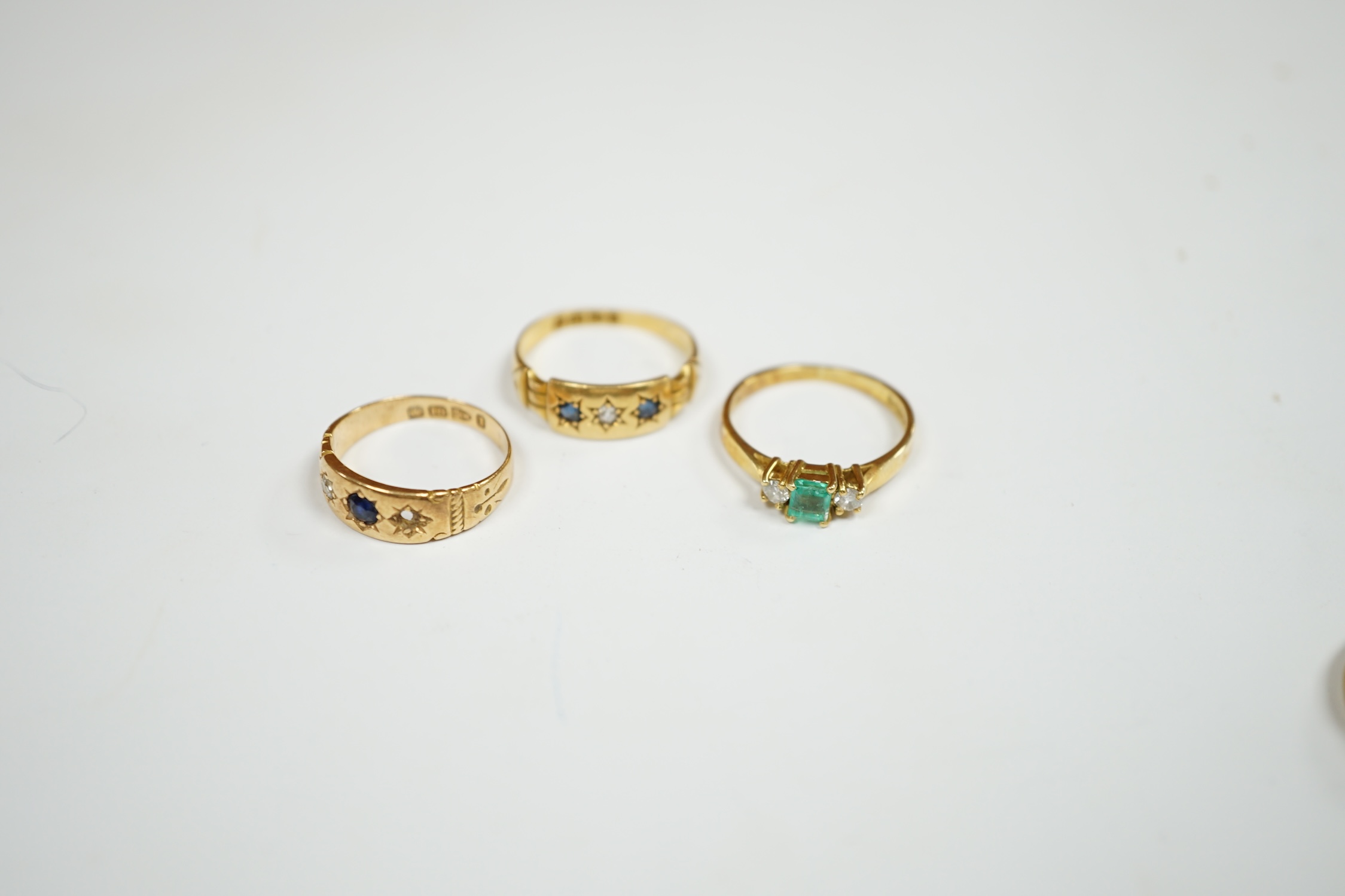 An Edwardian 18ct gold ring, size M, together with three other 18ct gold and gem set rings, including two early 20th century, gross weight 12.9 grams. Condition - fair